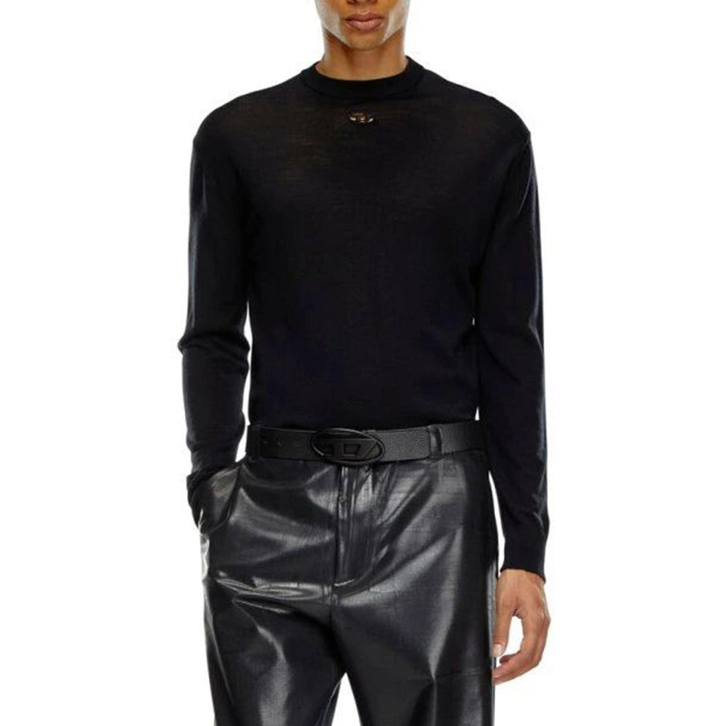 Lifestyle shot of the black sweater on a model in a studio setting