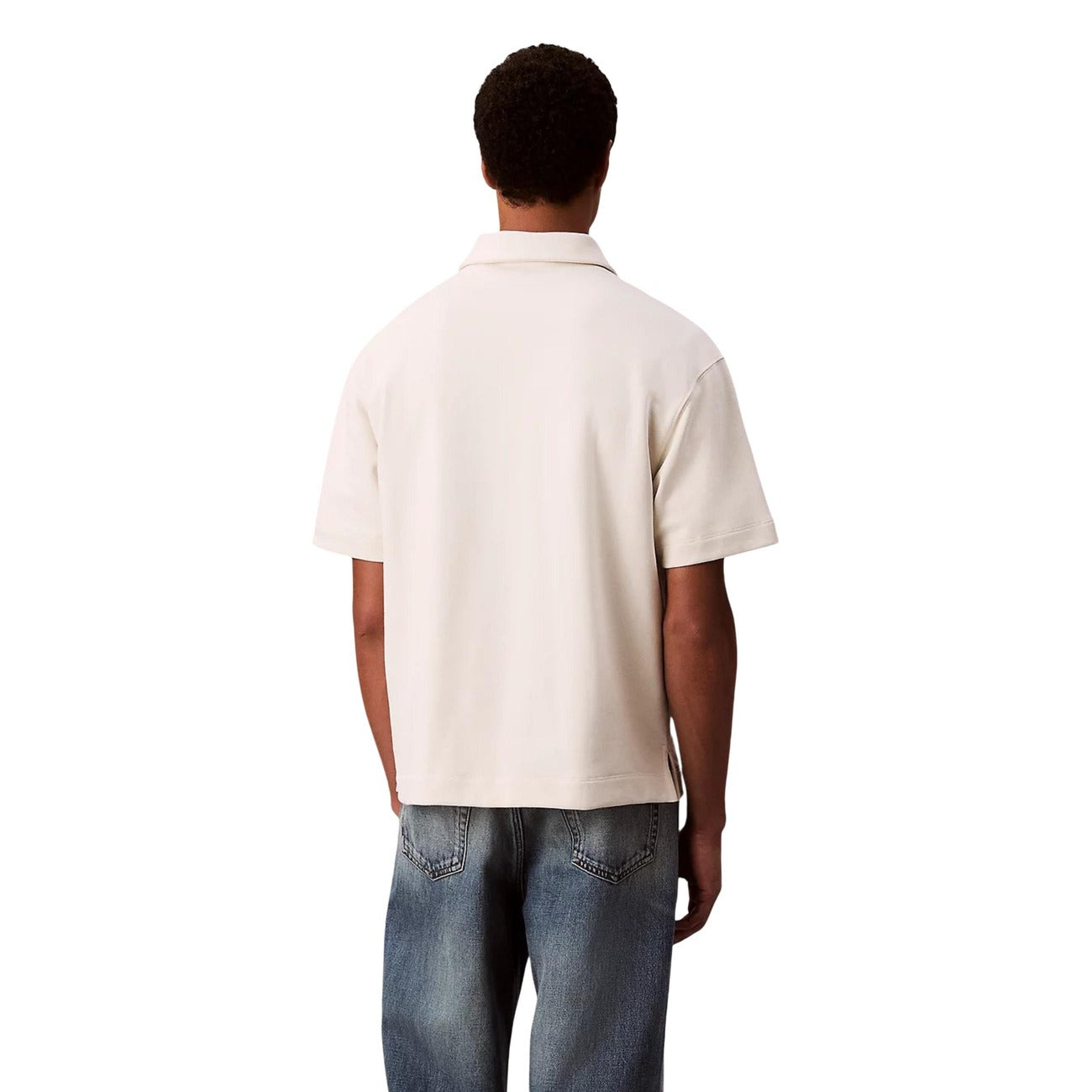 Back view of a beige polo shirt featuring short sleeves on a white background.