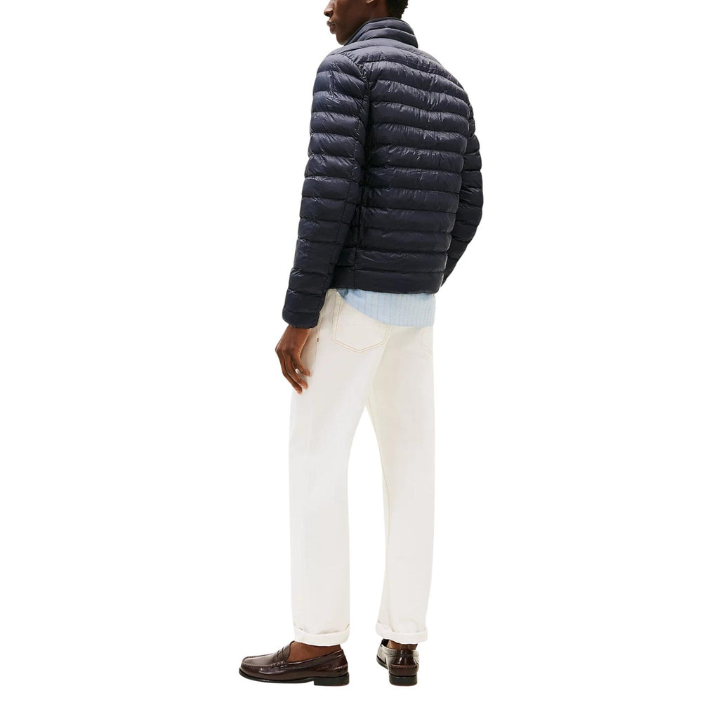 Back view of the navy puffer jacket showcasing the quilted design and collar on a white background.