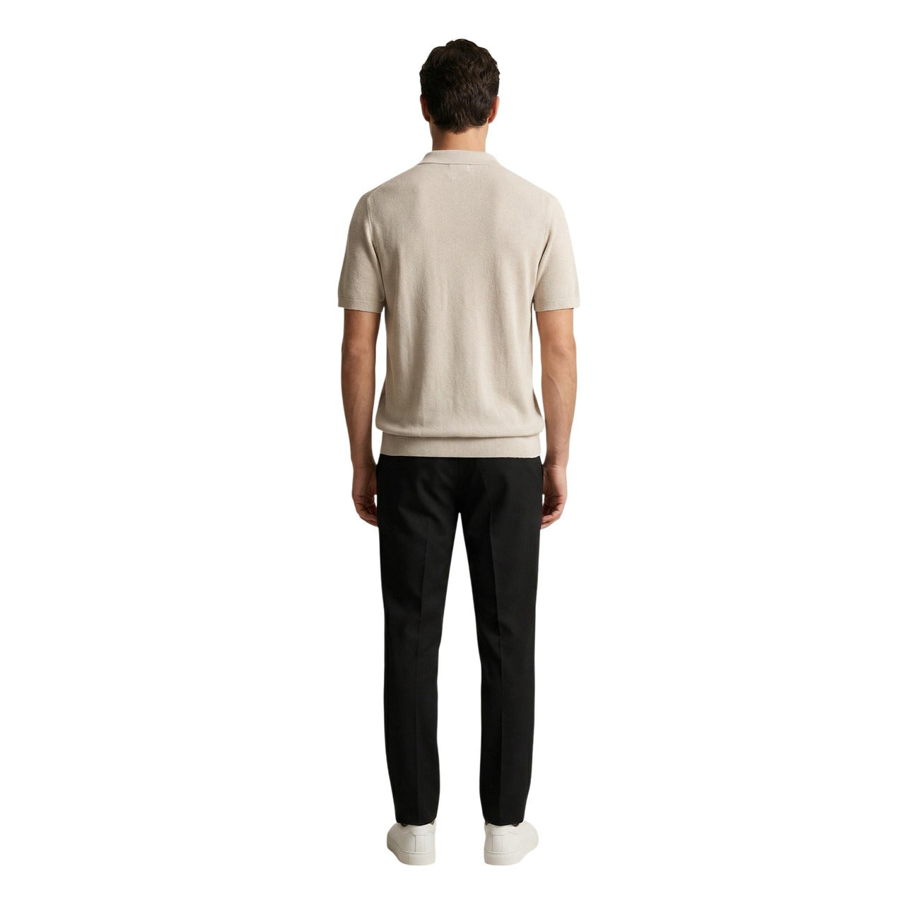 Back view of the beige polo shirt paired with black pants, highlighting short sleeves and a casual style on a white backgr…
