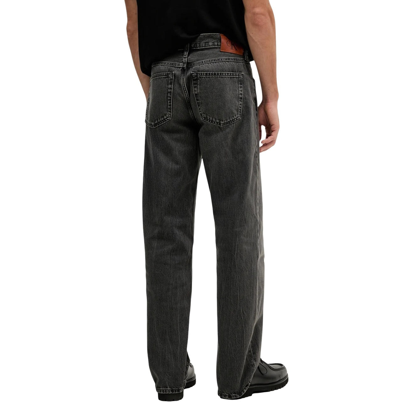 Back view of the black jeans showcasing the straight leg and five pockets against a white background.