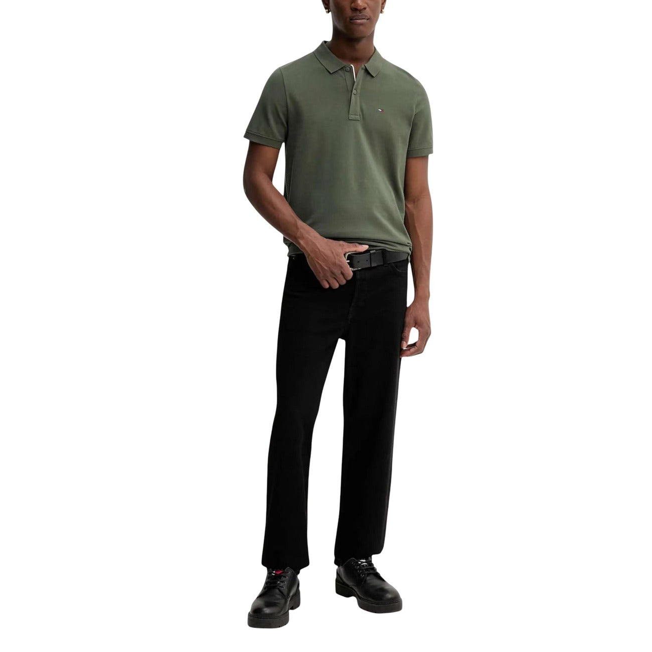 Lifestyle shot of a man wearing a green polo in a casual outfit, standing pose.