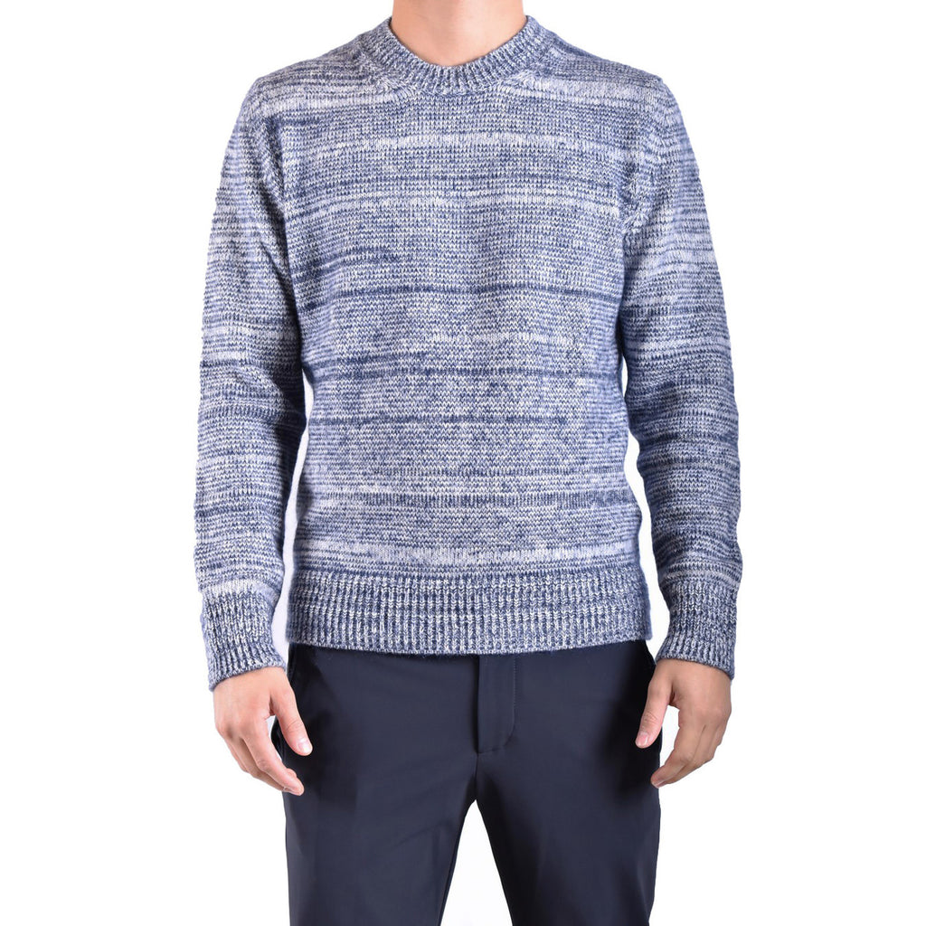 Lifestyle shot of the blue striped sweater with long sleeves and a v-neck in a studio setting.