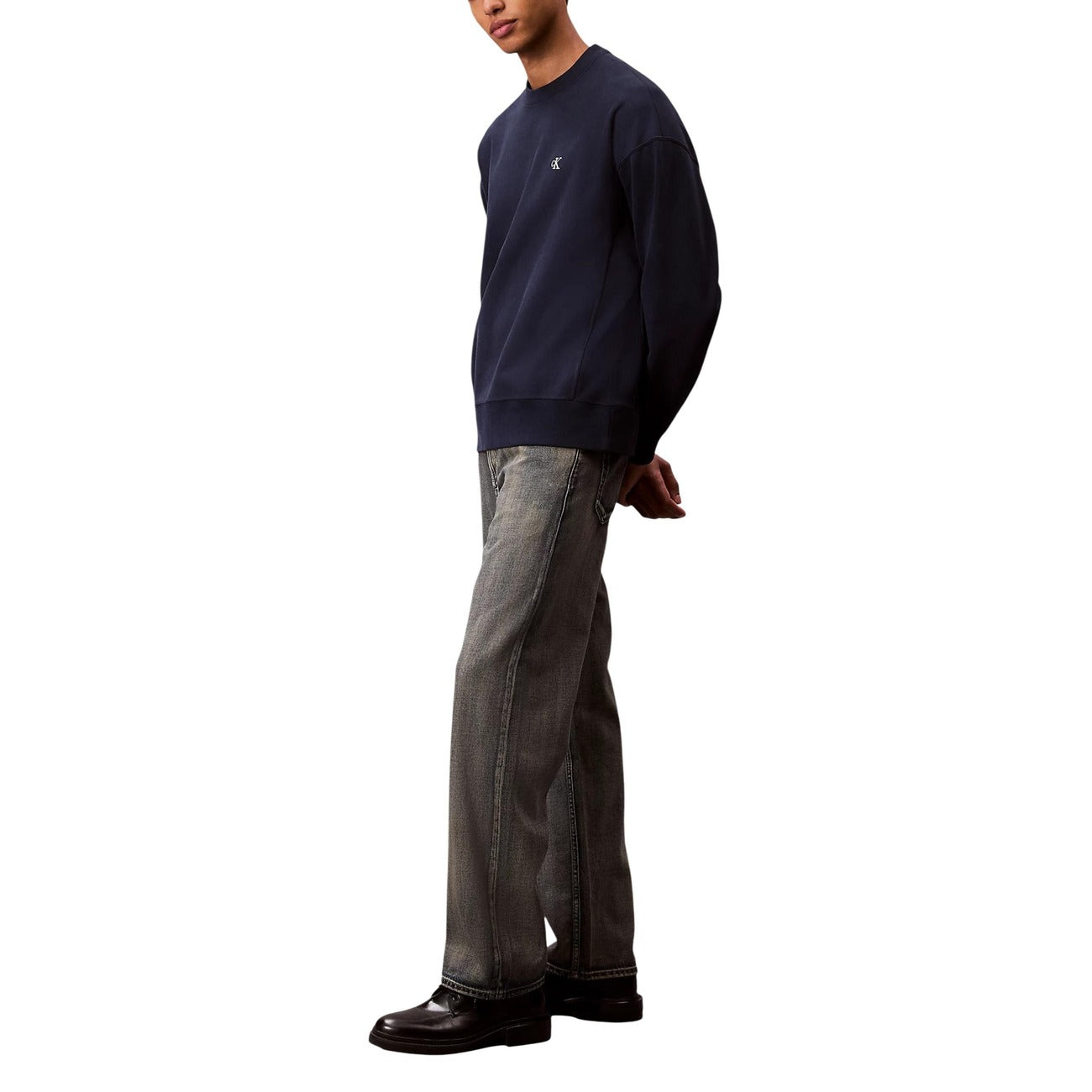 Back view of beige Calvin Klein Jeans featuring straight leg and pockets on a white background