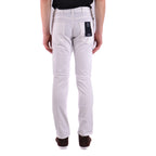 Back view of the white pants showing pockets and a tag attached on a white background