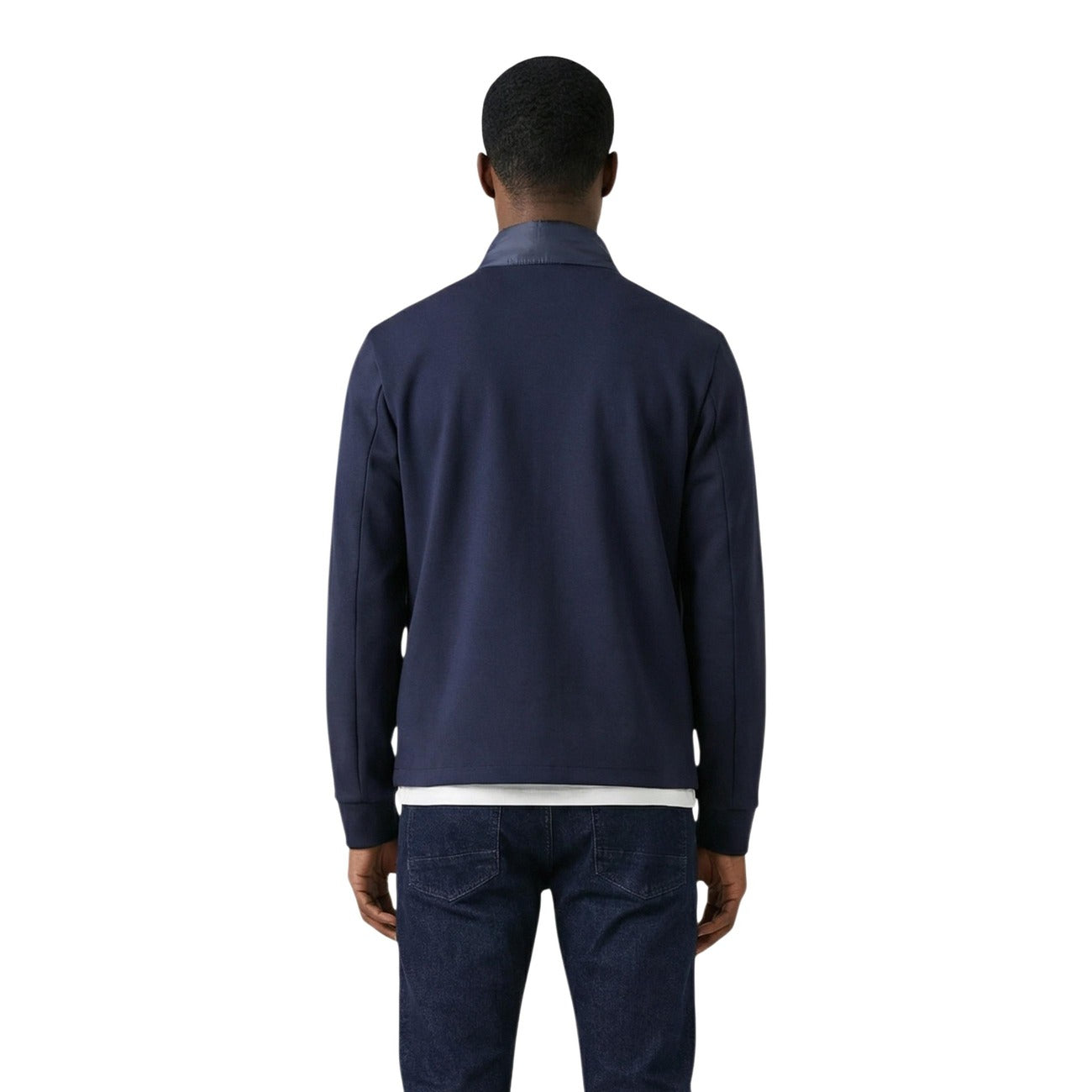 Front view of the navy puffer jacket paired with pants, highlighting the zipper closure and quilted design.