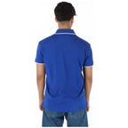 Back view of the blue polo shirt with a collar and short sleeves on a white background