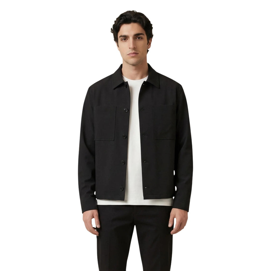 Front view of the black blazer featuring a classic collar and front pockets.