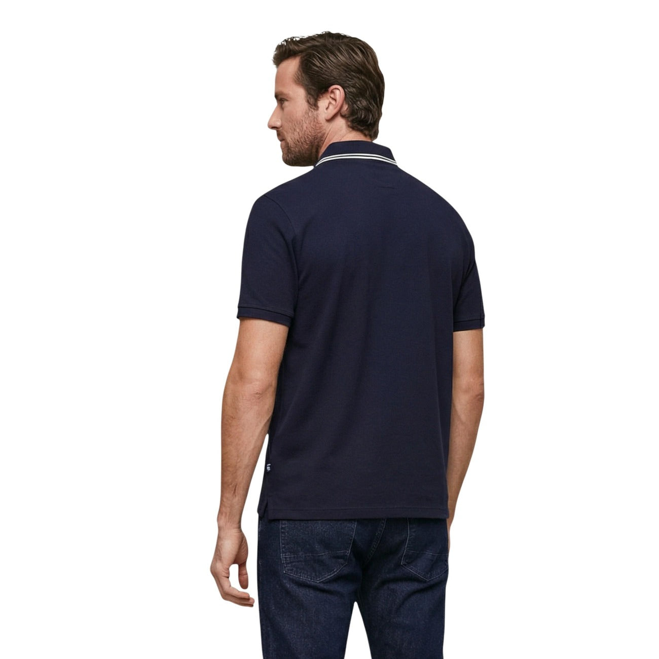 Back view of the navy polo shirt showcasing short sleeves and logo on back against a white background.