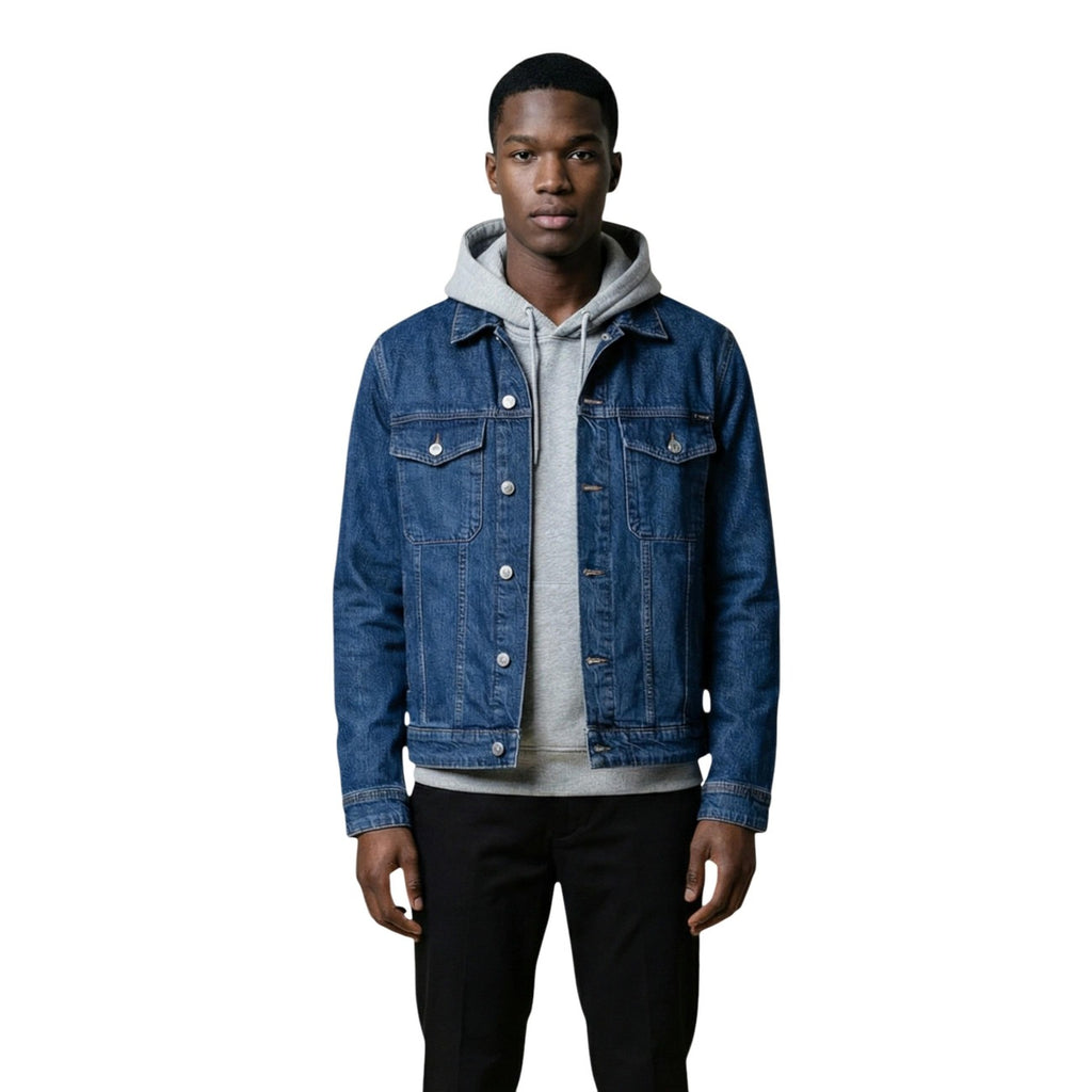 Lifestyle shot of a blue denim jacket with button closure against a white background
