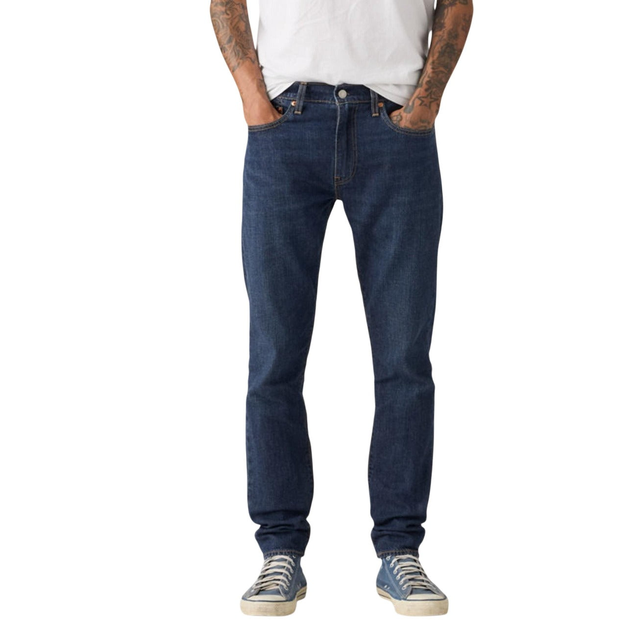 Lifestyle shot of blue jeans with slim fit and five pockets against a white background.