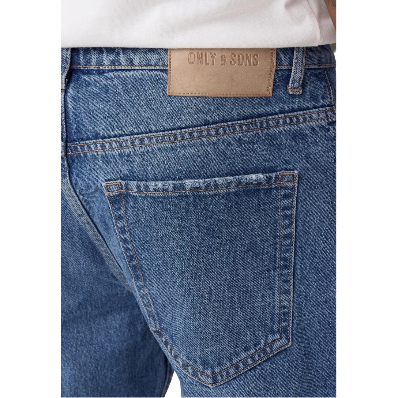 Close-up detail of light blue jeans showing back pocket and brand label on a white background