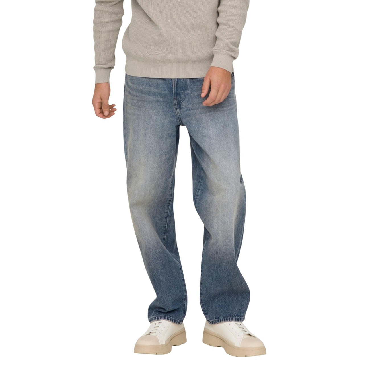 Lifestyle shot of a man in light blue faded denim jeans, loose fit, on a white background.