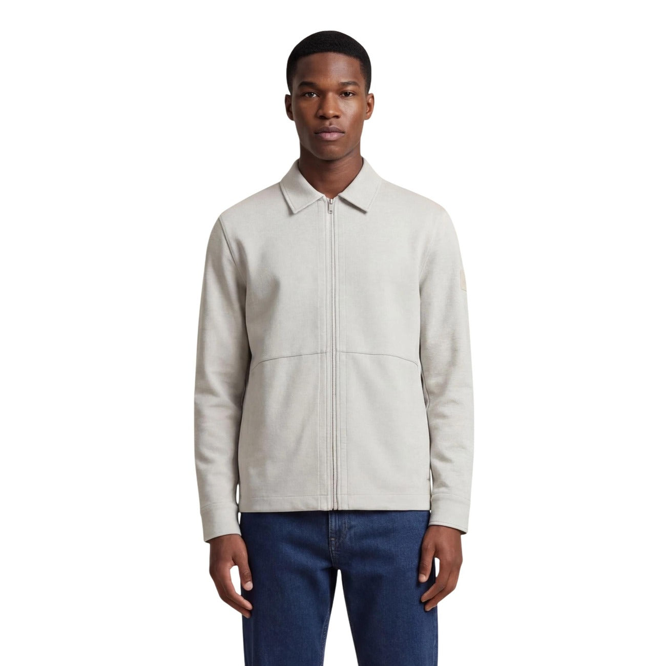 Lifestyle shot of a model wearing the light gray Boss polo jacket with zipper closure in a studio setting