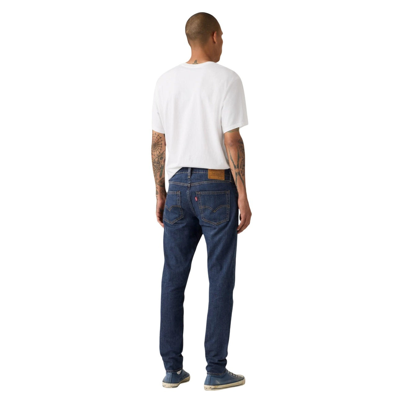 Back view of blue jeans featuring slim fit and five pockets on a white background.