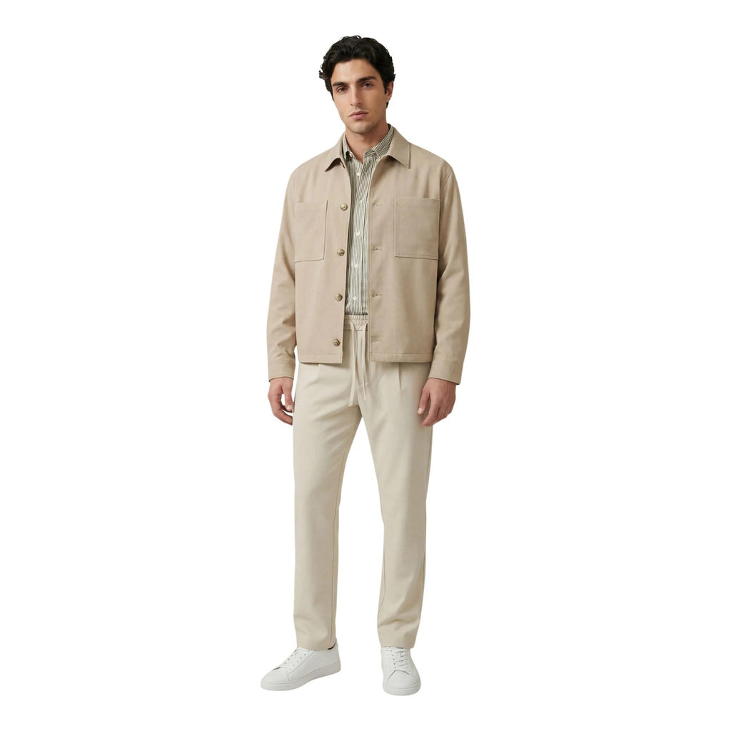 Lifestyle shot of the beige blazer paired with pants, featuring a collar and button closure against a white background.