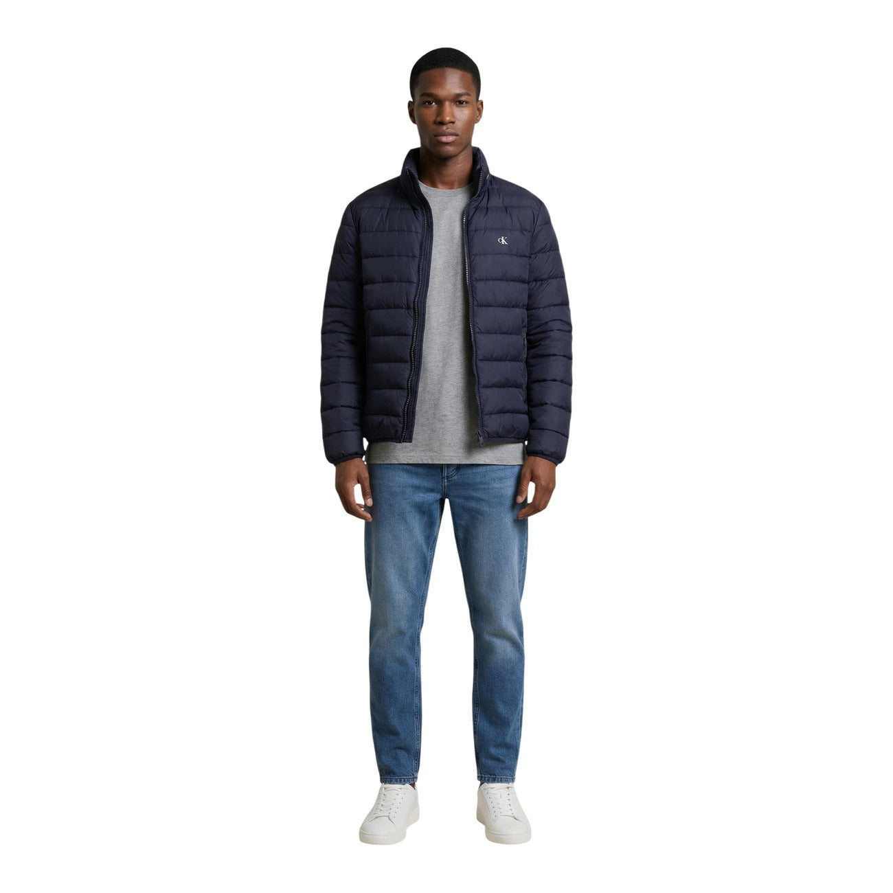 Back view of the navy puffer jacket showcasing the zipper closure and quilted design against a white backdrop
