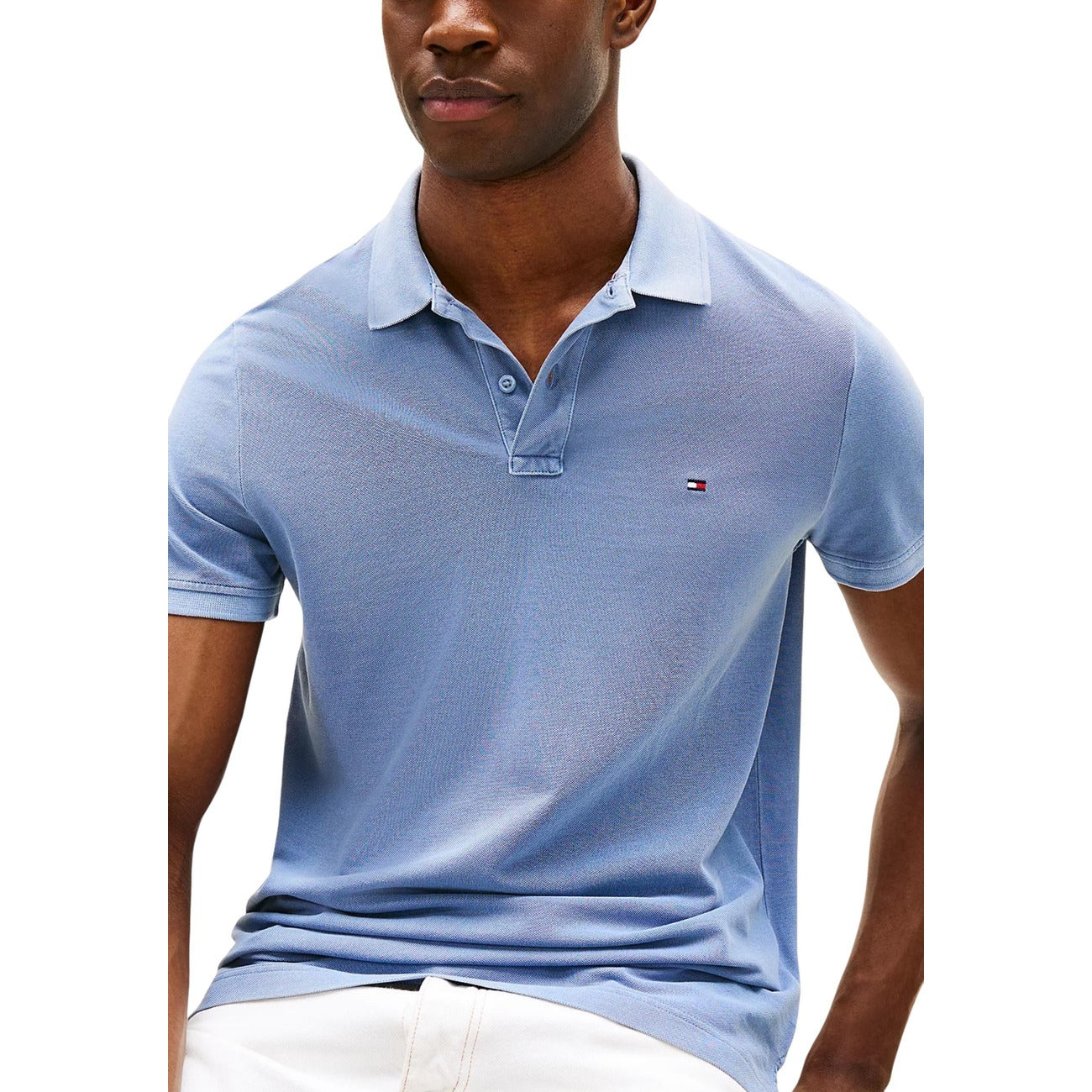 Detail close-up of the blue polo shirt showcasing the collar and logo on a white background.