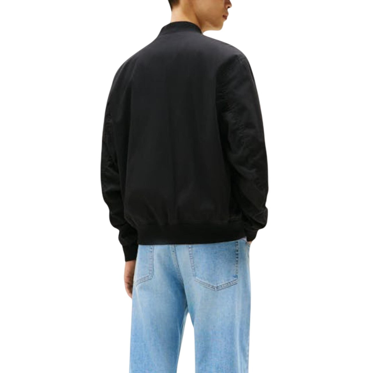 Back view of the black bomber jacket showcasing a plain back and elastic cuffs on a white background.