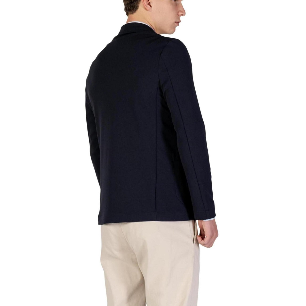 Back view of the navy blazer showcasing its simple design and tailored fit.