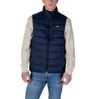 Front view of the navy puffer vest featuring a zipper closure and padded design.