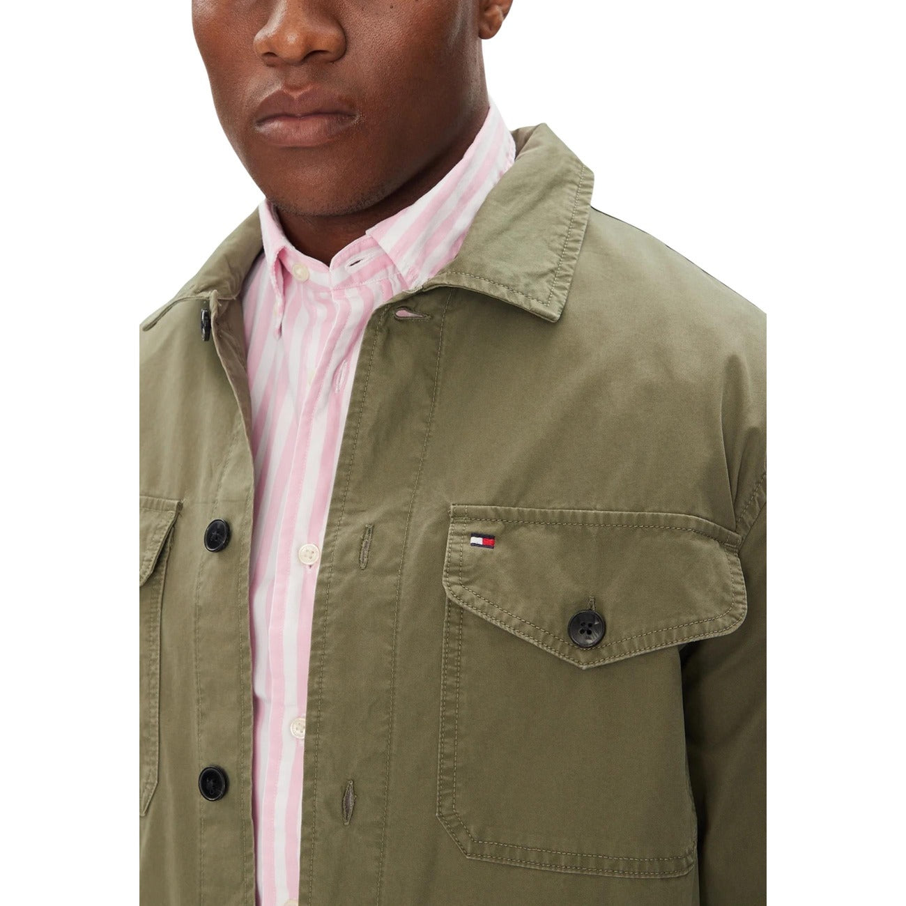 Close-up detail of the green blazer highlighting the collar and fabric texture.