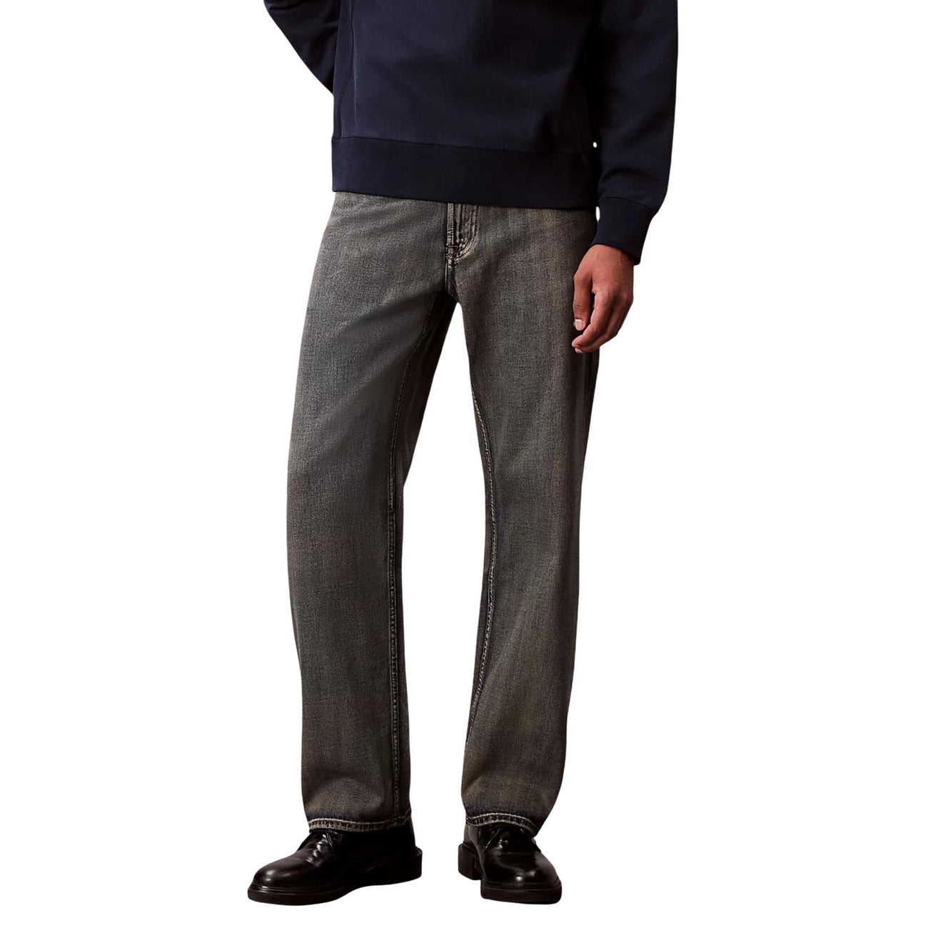 Front view of beige Calvin Klein Jeans with straight leg and pockets on a white background
