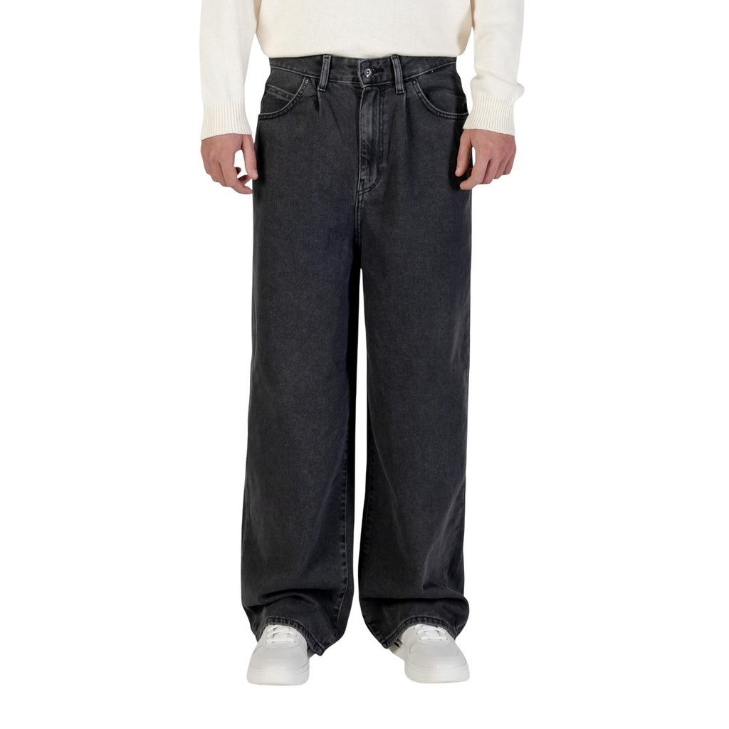 Lifestyle shot of black wide-leg pants featuring an elastic waistband and casual fit on a natural background