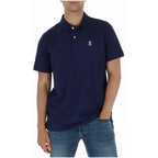 Front view of the navy polo shirt featuring short sleeves and logo embroidery on a white background.