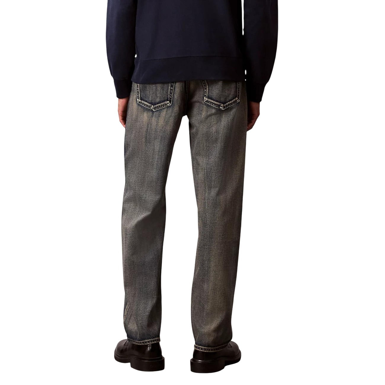 Lifestyle shot of beige Calvin Klein Jeans with straight leg and pockets against a white background