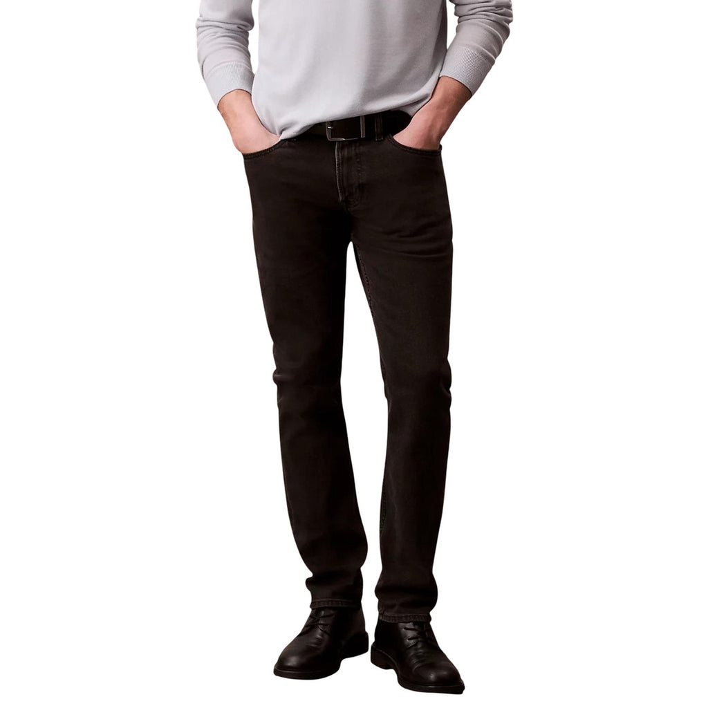 Front view of the black jeans featuring slim fit and pocket details on a white background