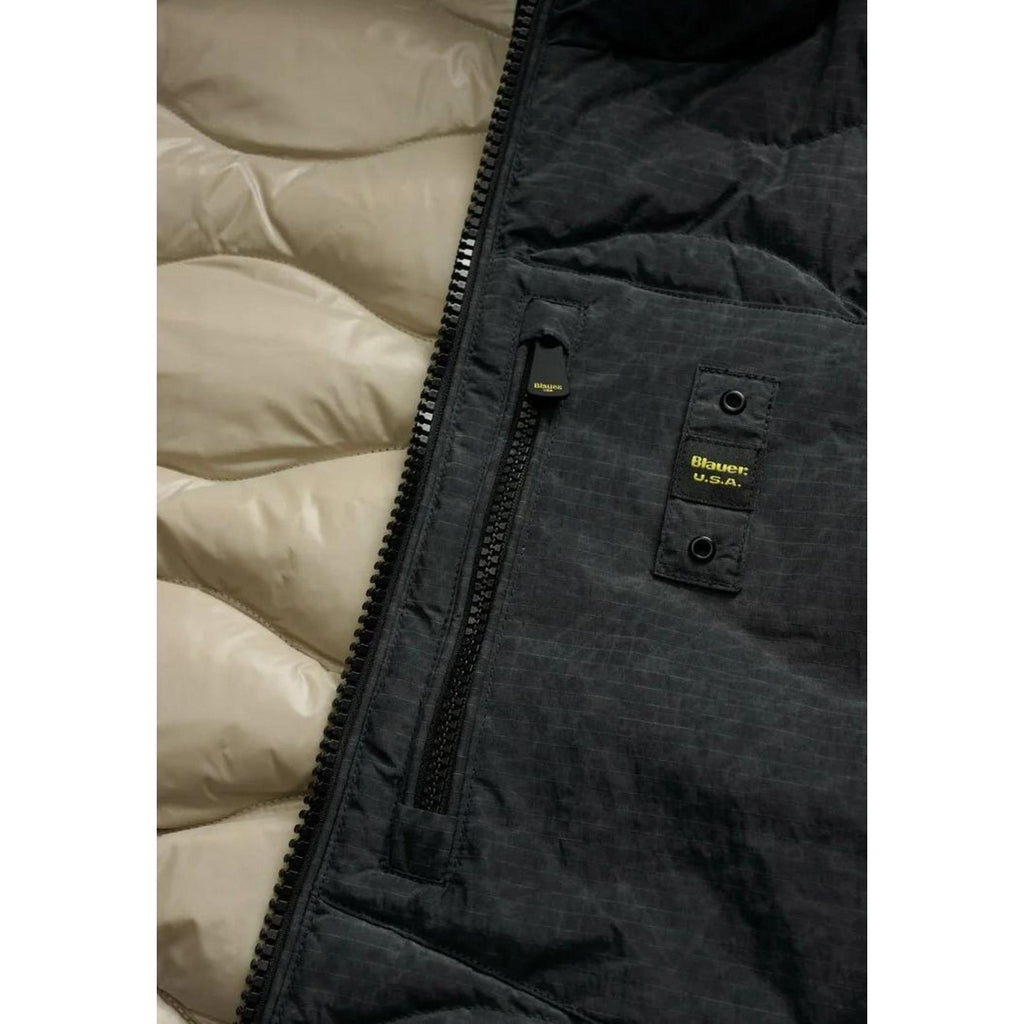 Detail close-up of the black jacket's interior showing zipper pocket and padded lining.