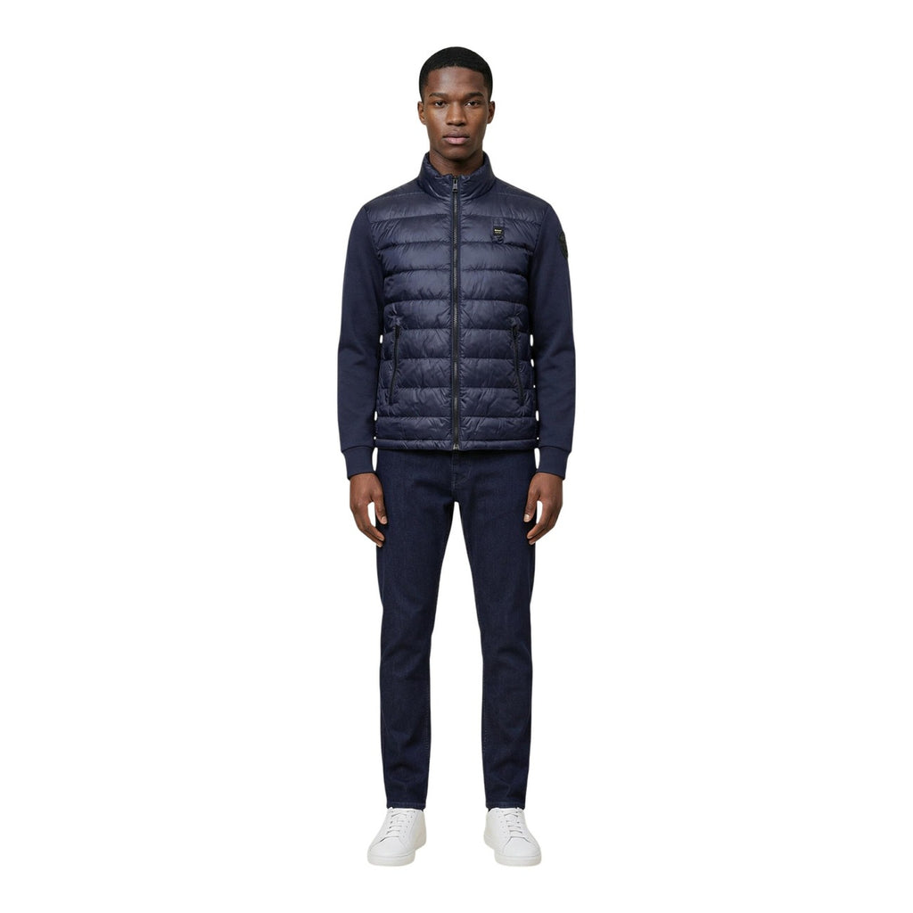 Back view of the navy puffer jacket showcasing the quilted design and collar.