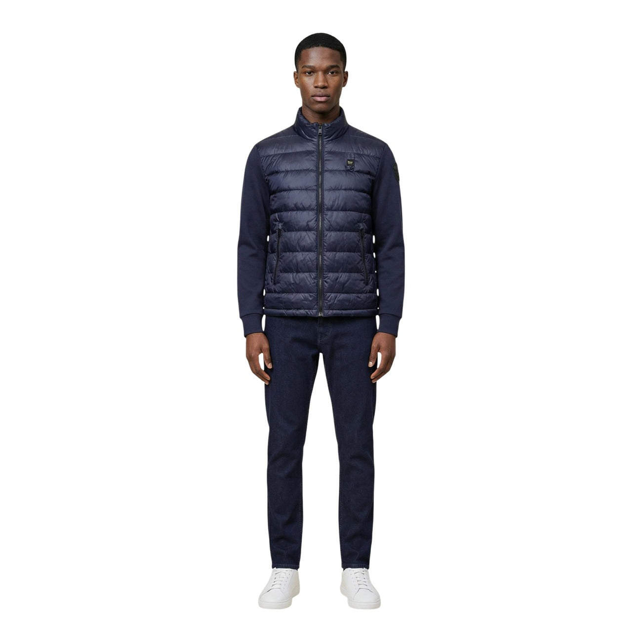 Back view of the navy puffer jacket showcasing the quilted design and collar.