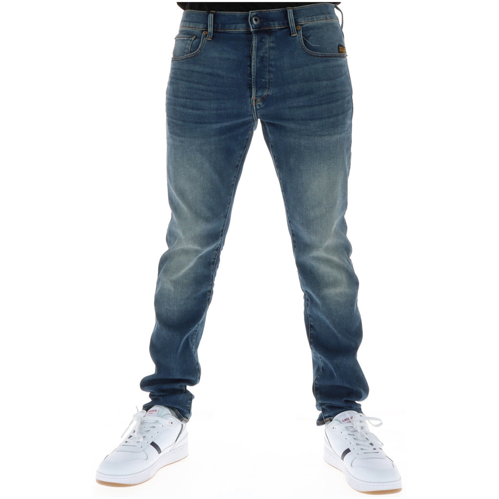 Front view of blue jeans featuring a faded wash and slim fit on a white background