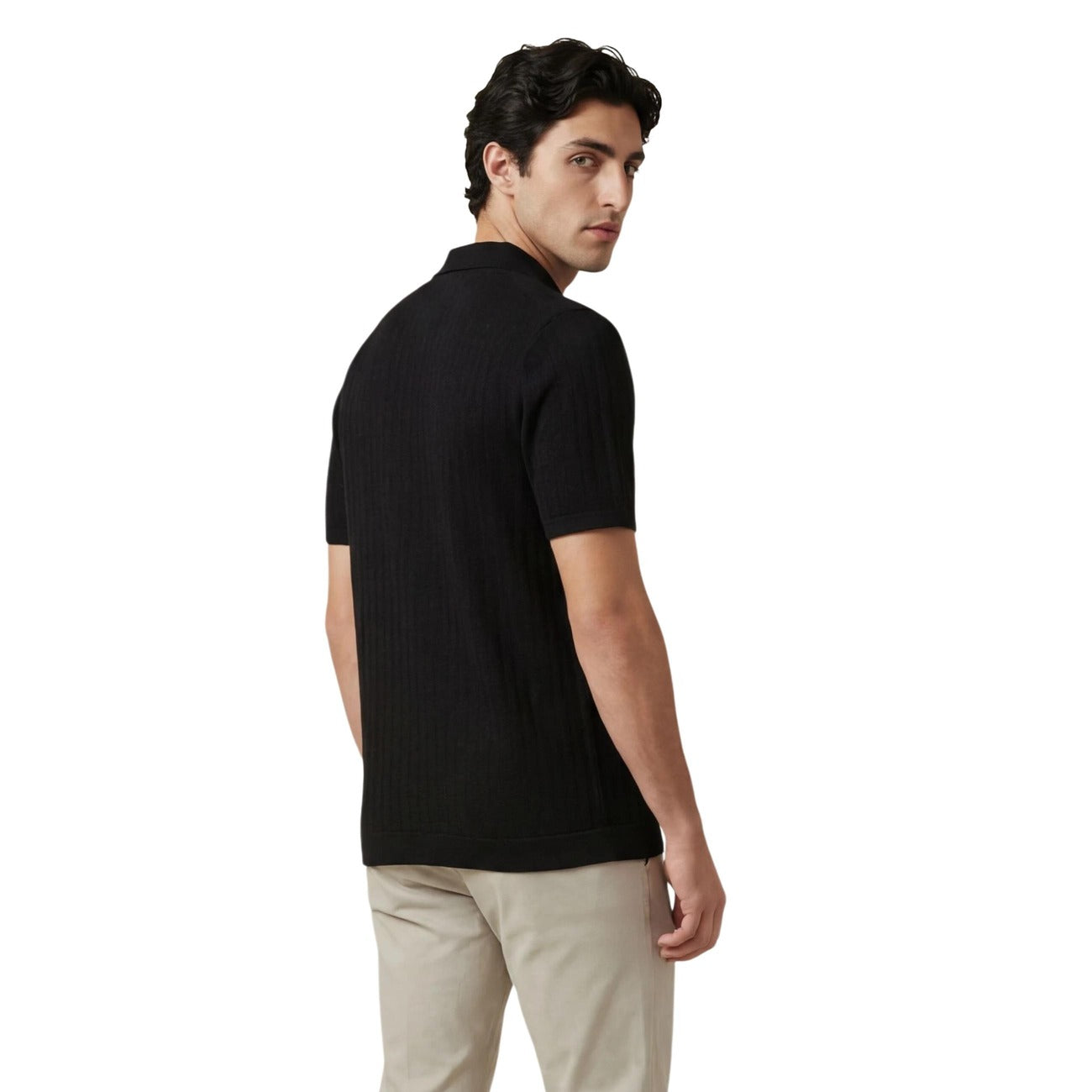 Back view of the black polo shirt showcasing short sleeves and a collar.