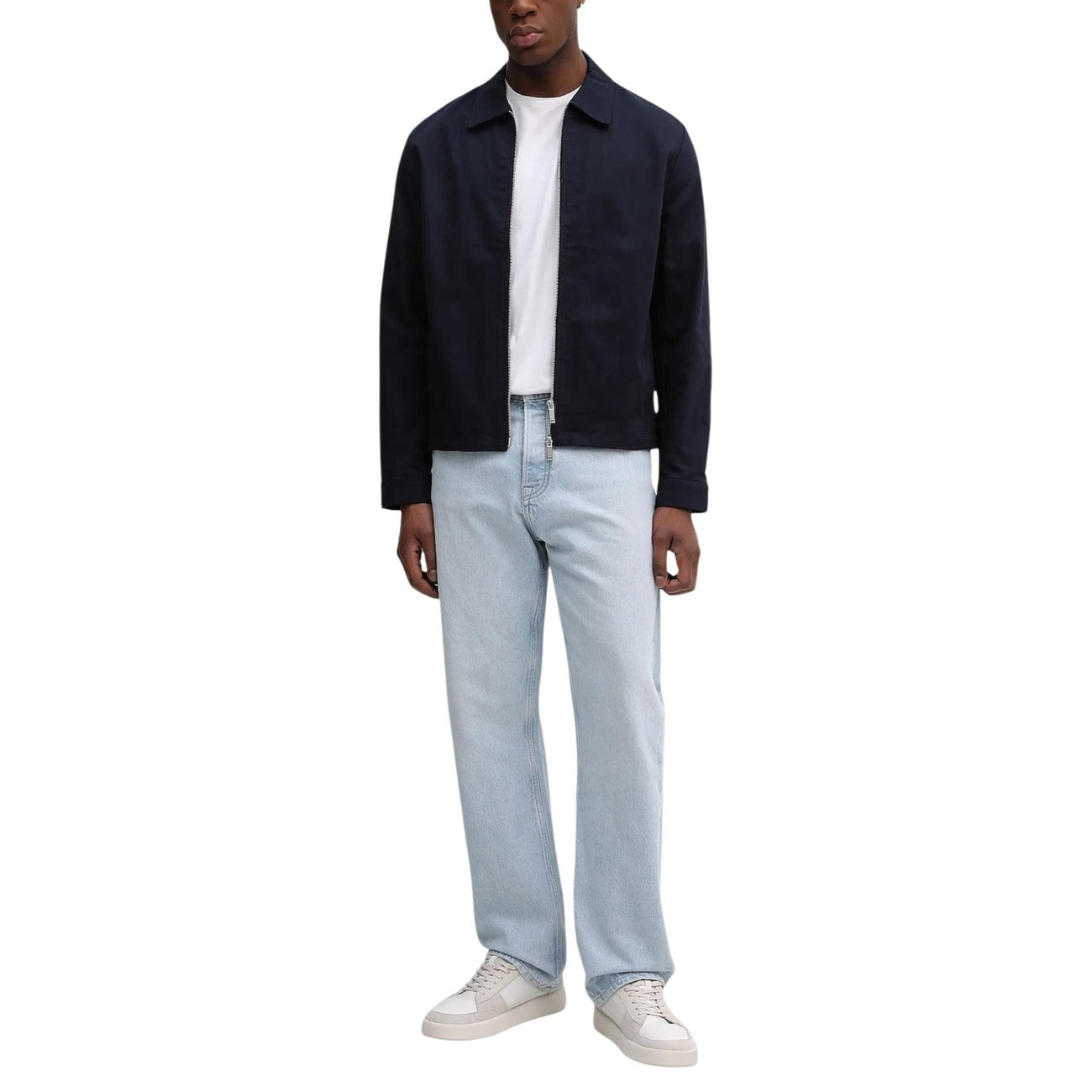 Lifestyle shot of the navy blazer paired with jeans and a white t-shirt on a white background.