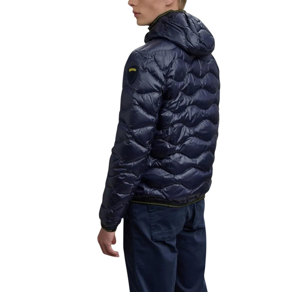 Back view of the navy puffer jacket showcasing the hood and quilted design on a white background.