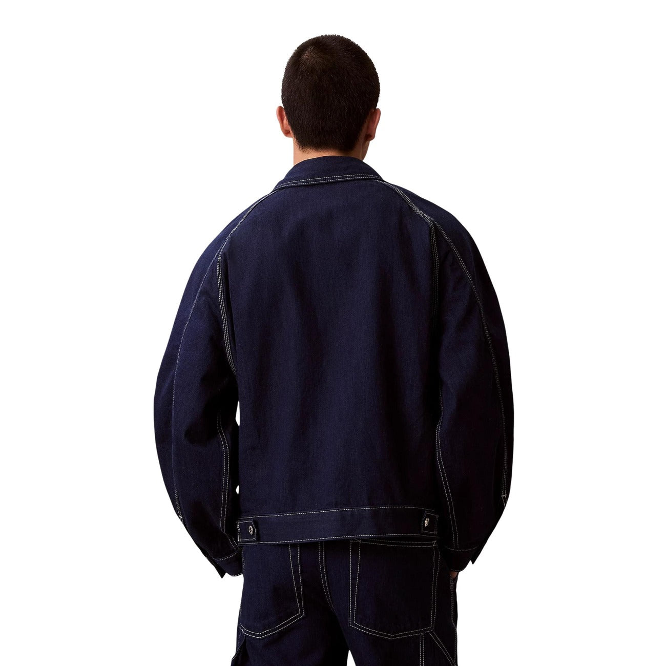 Back view of a navy denim blazer showcasing the collar and pockets against a white background.