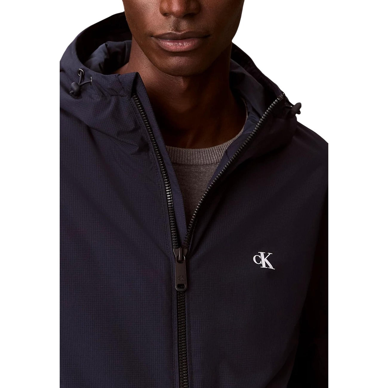 Front view of a navy hoodie with a front pocket and zipper closure on a white background.
