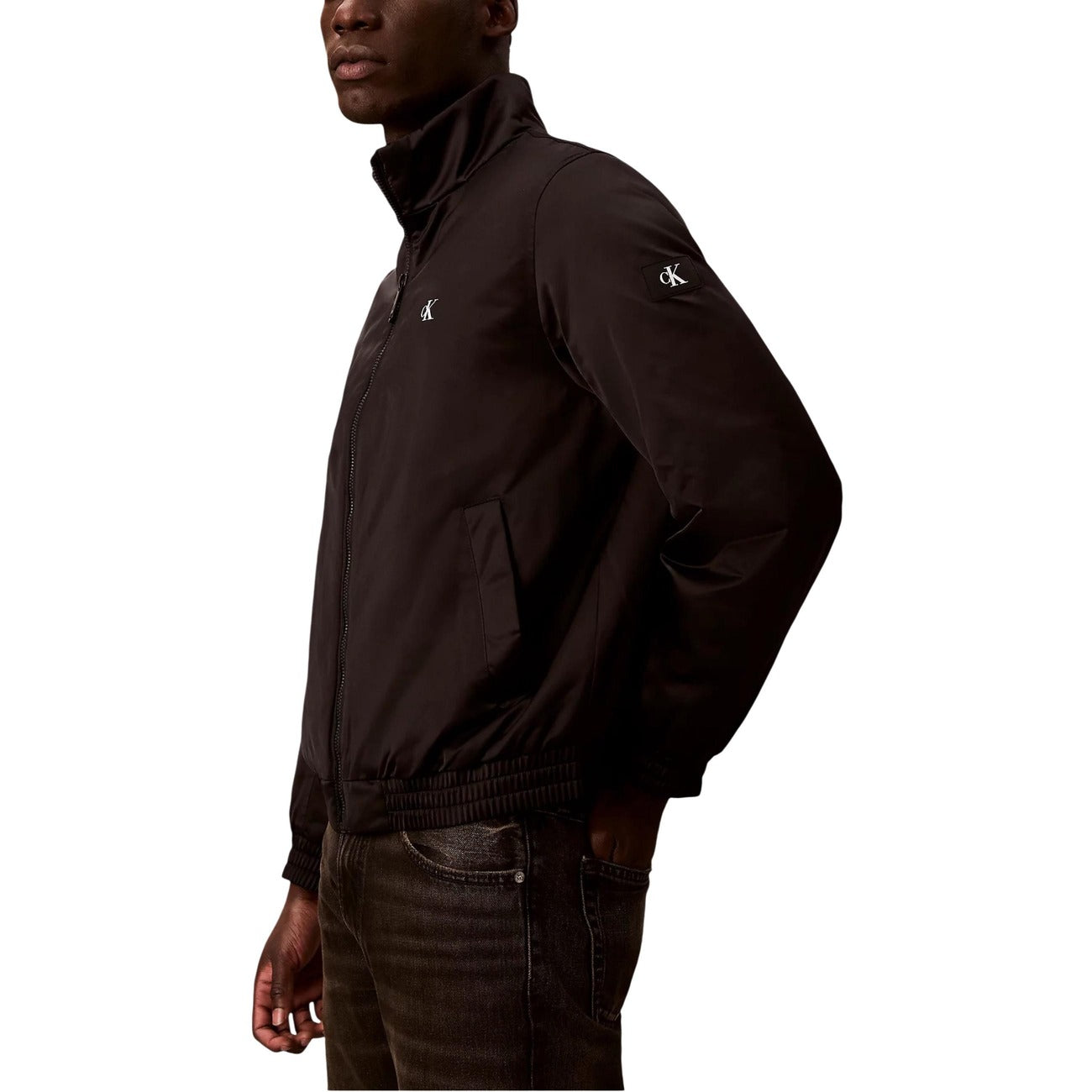 Side view of the black Calvin Klein Jeans blazer showcasing the zipper closure and high collar.