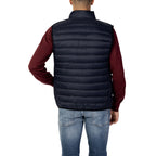 Back view of the navy puffer vest showcasing padded design with no visible logo on a white background.