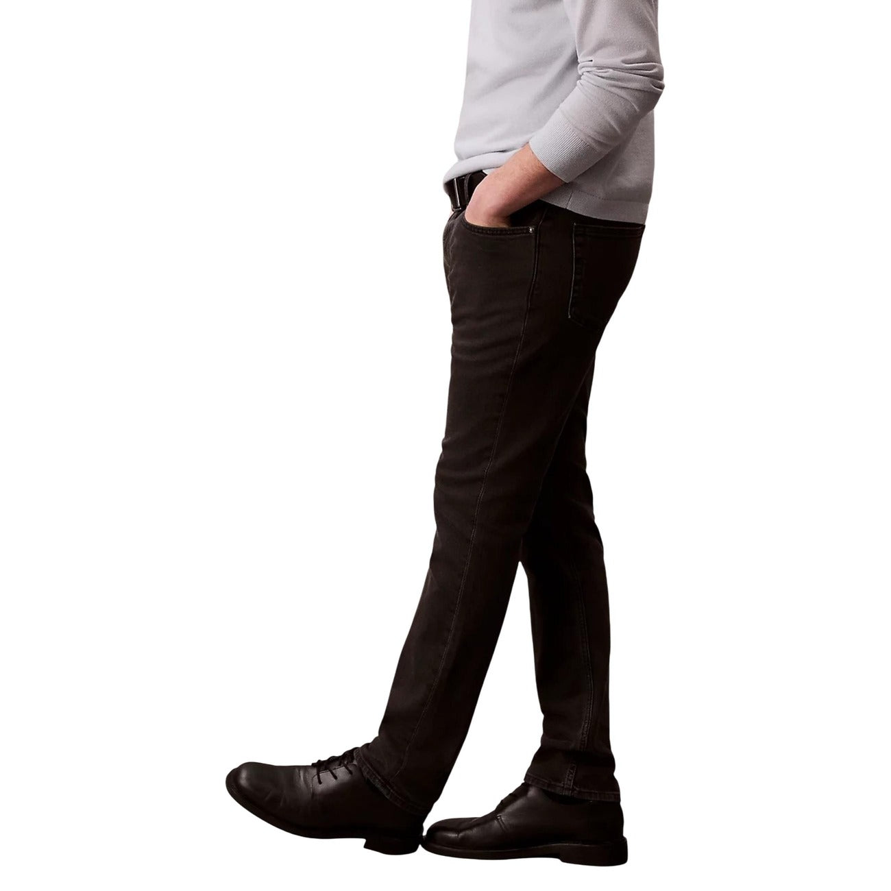 Side view of the black jeans highlighting slim fit and pocket details on a white background