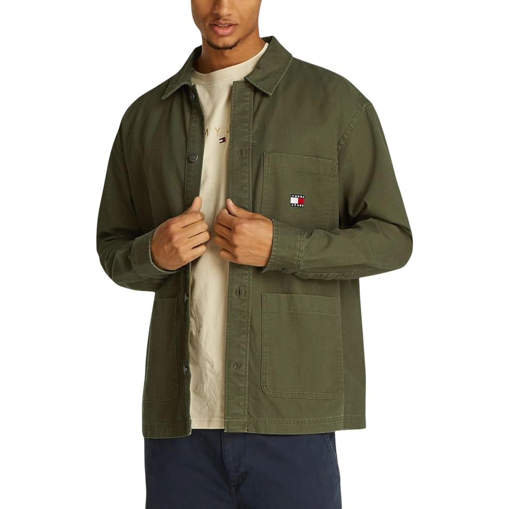 Lifestyle shot of a green blazer with button closure and long sleeves against a white background.