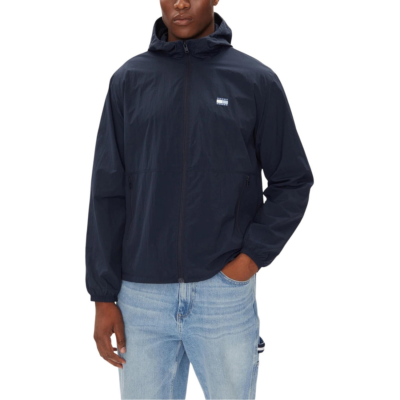 Lifestyle shot of a navy hooded blazer featuring a zipper closure.