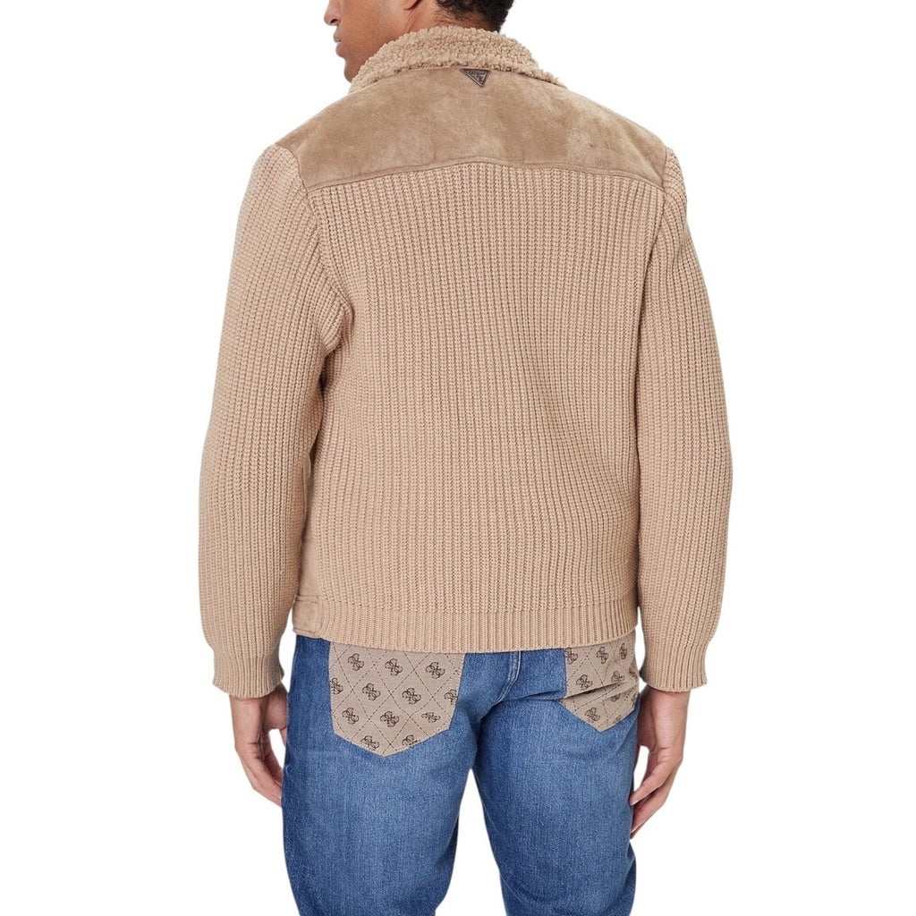 Lifestyle shot of the beige Guess men jacket paired with jeans and sneakers.