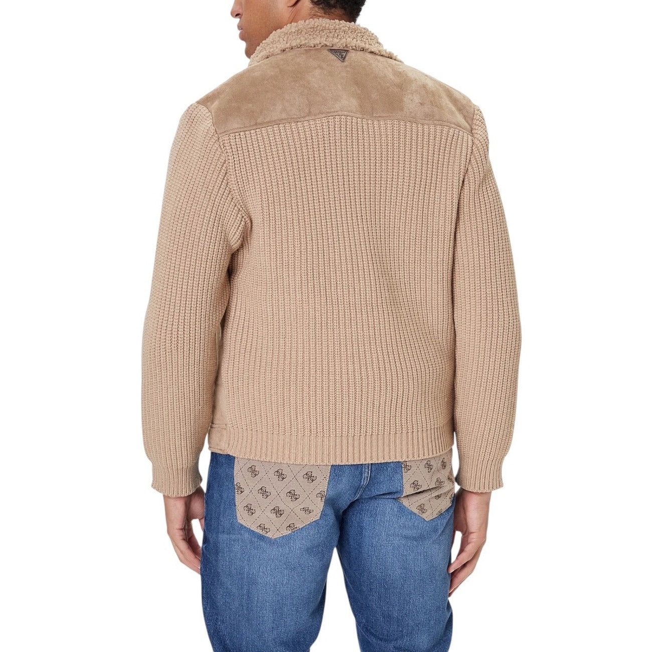 Lifestyle shot of the beige Guess men jacket paired with jeans and sneakers.