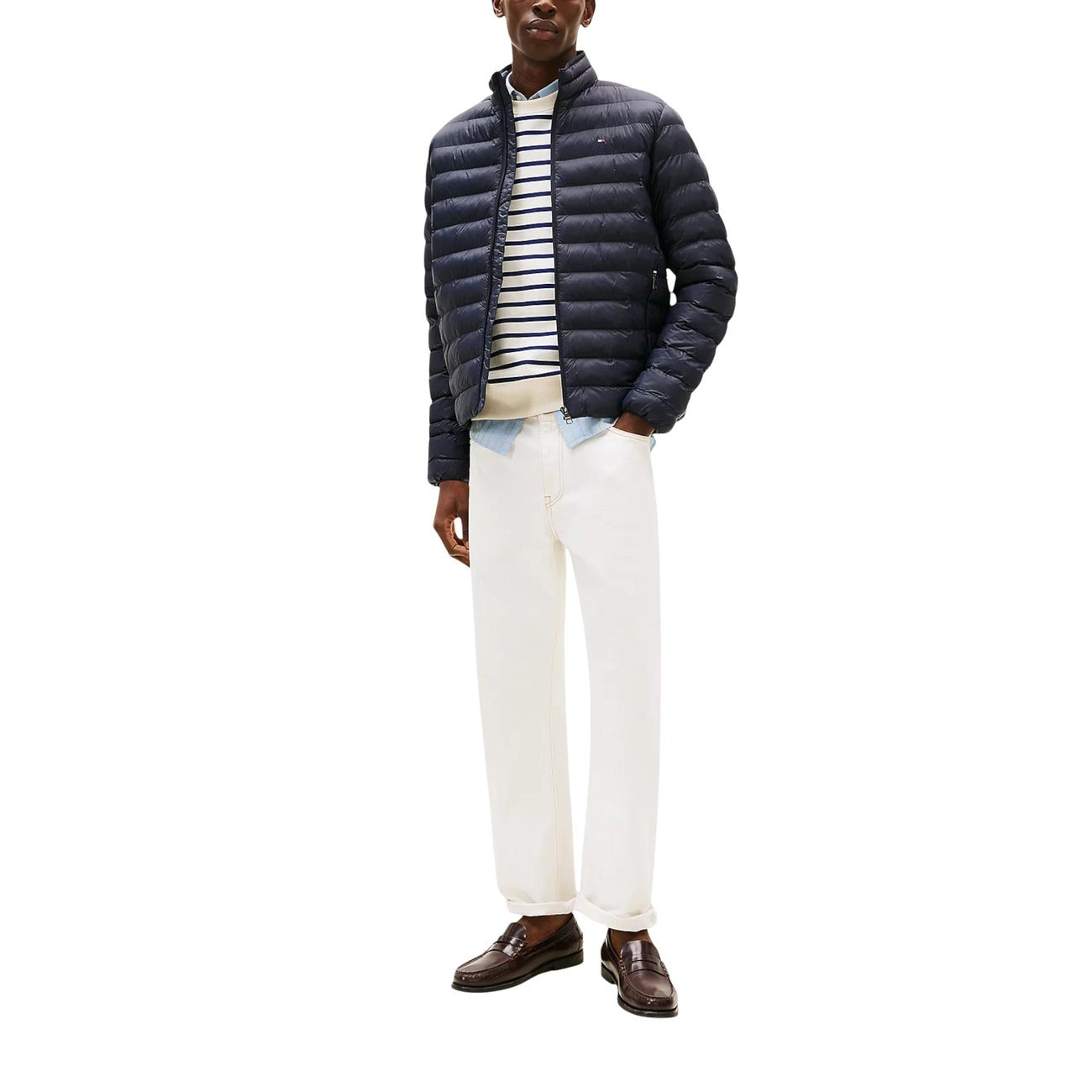 Lifestyle shot of the navy puffer jacket in a casual outfit, highlighting its quilted design on a white background.