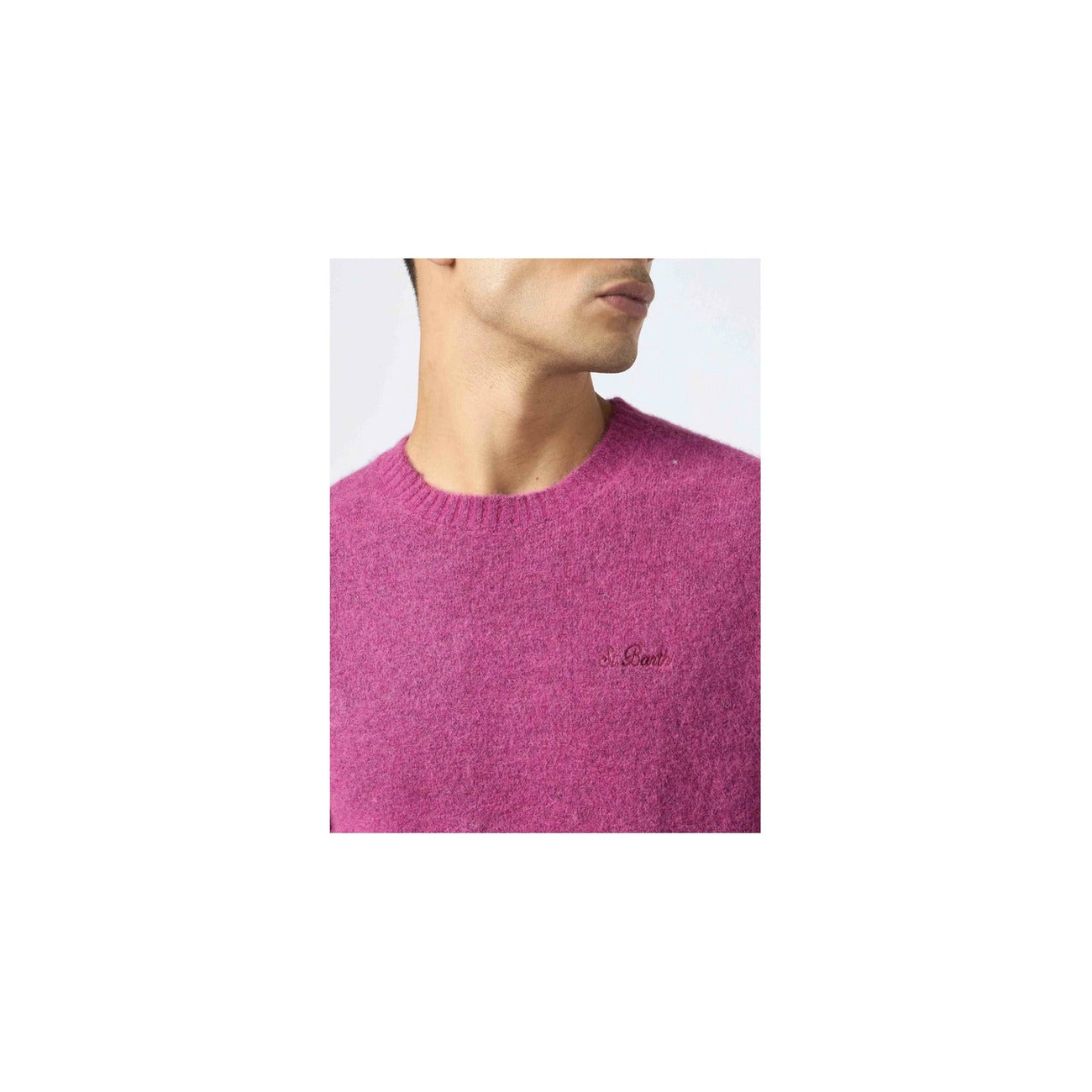 Detail close-up of the fuchsia knitwear showcasing the crew neck and embroidered logo on a white background