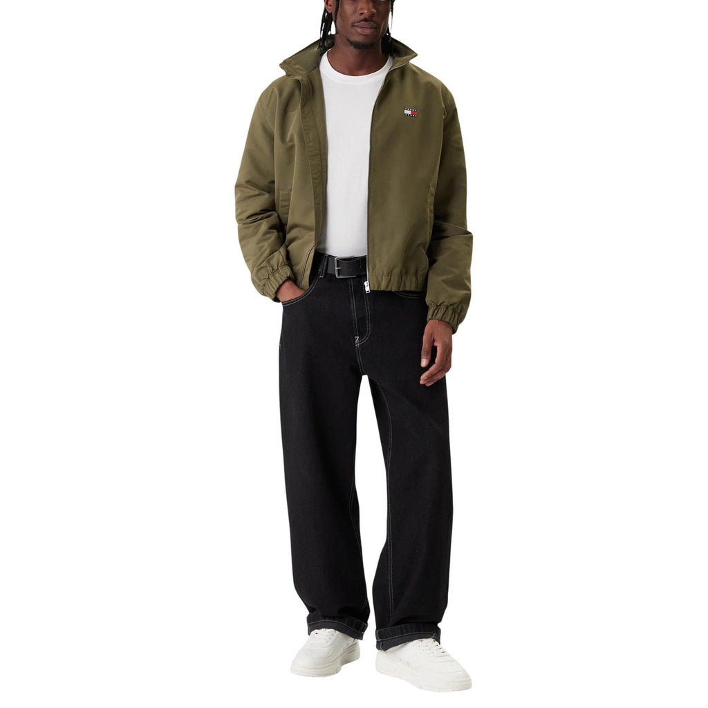 Back view of the olive green jacket showcasing its casual style in a studio setting.